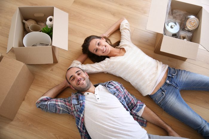 Couple Laying on Floor After Packing Boxes